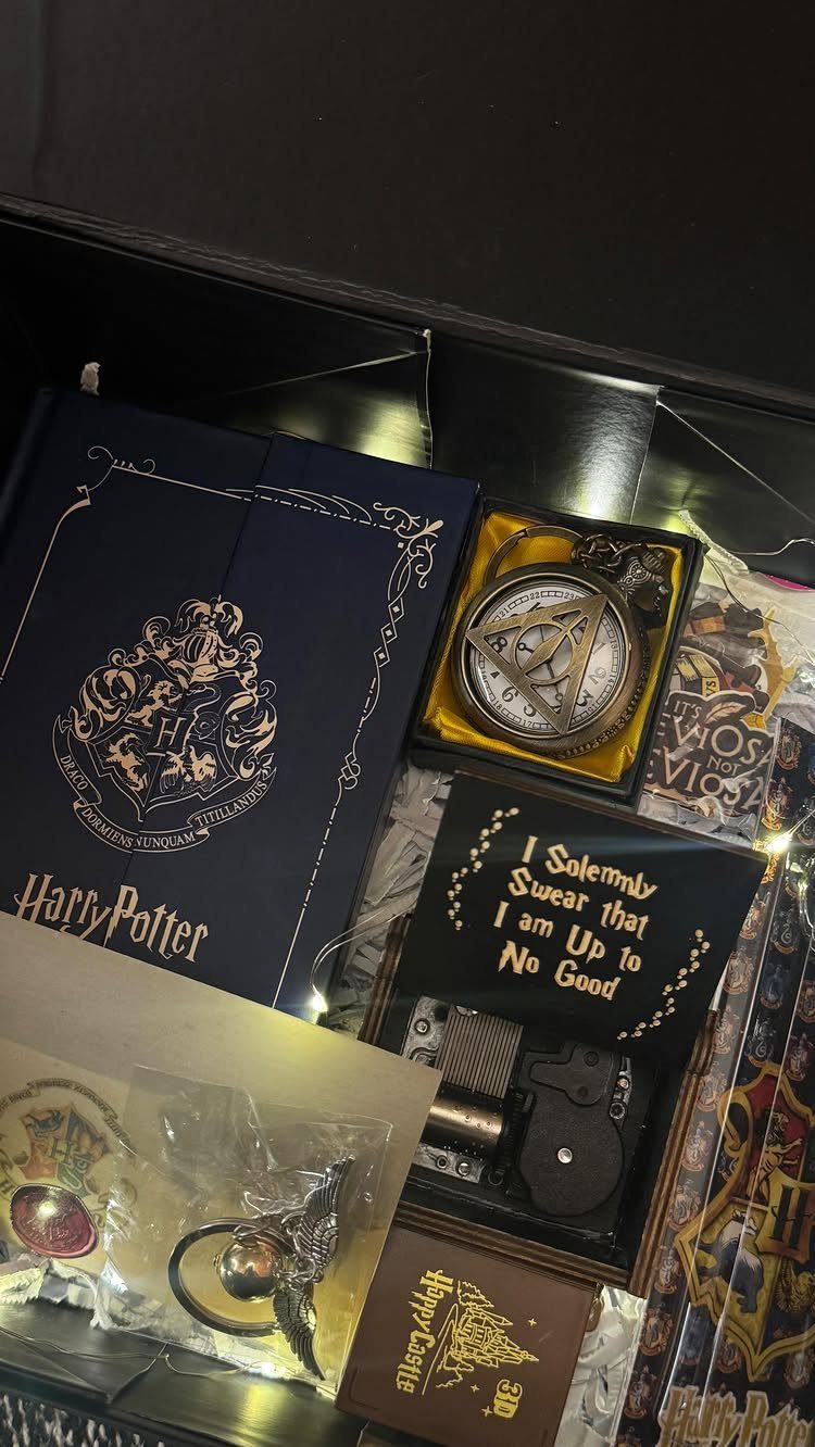 25 Best Harry Potter Gifts for Every Wizarding Fan in 2026 25 Harry Potter themed gift set featuring a blue book, pendant, and gold-lettered plaque.