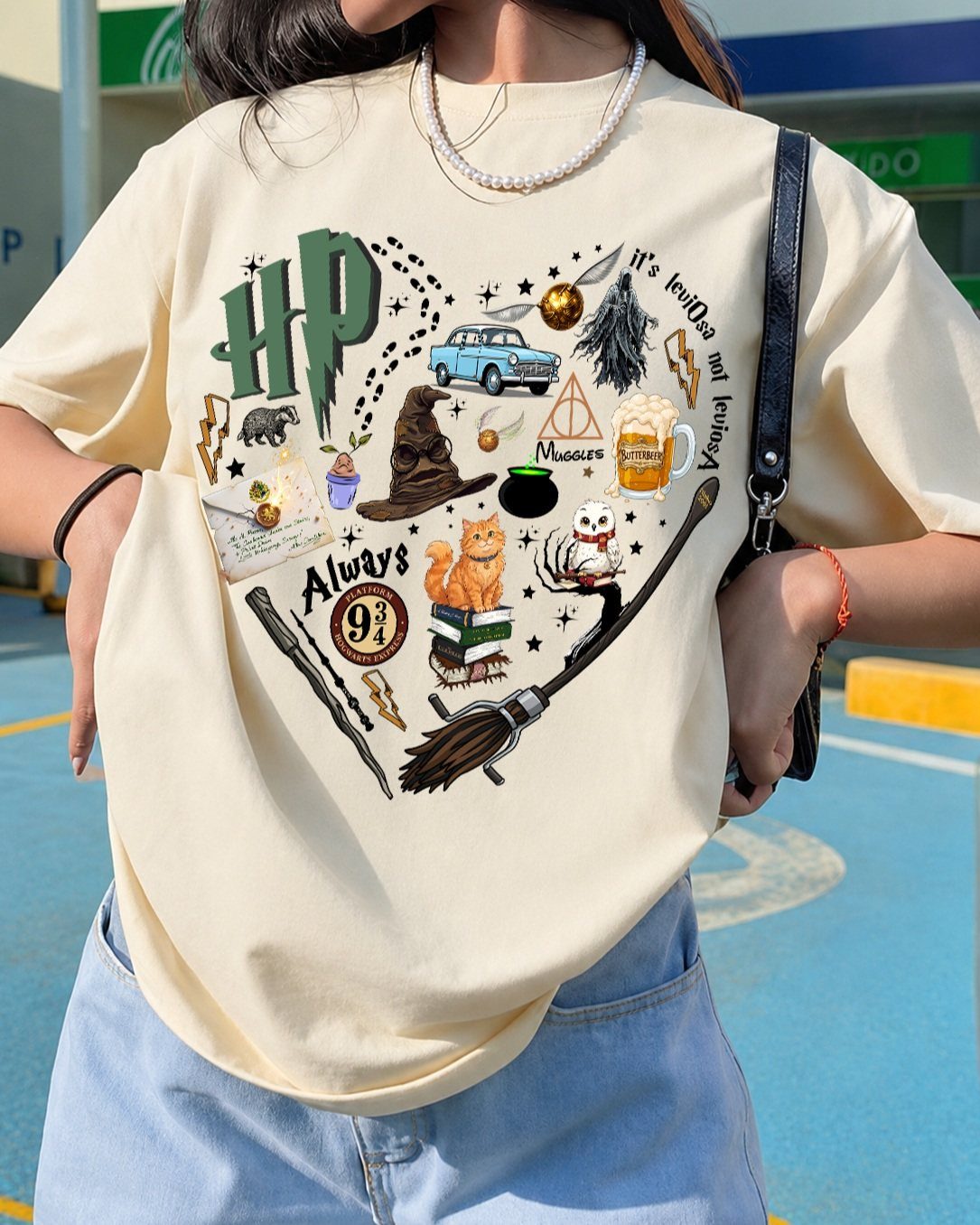 25 Best Harry Potter Gifts for Every Wizarding Fan in 2026 21 Cream t-shirt with Harry Potter heart collage worn by a person in jeans