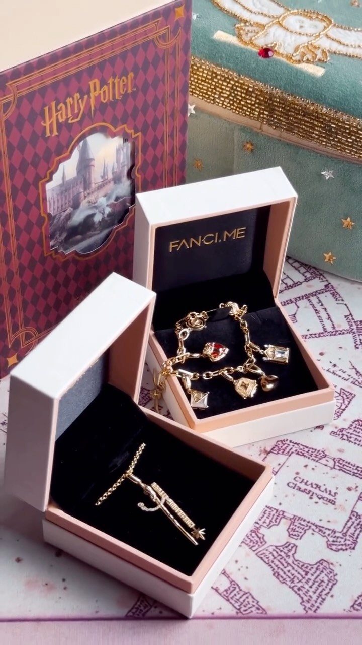 25 Best Harry Potter Gifts for Every Wizarding Fan in 2026 6 Gold-toned Harry Potter charm bracelet and wand necklace in white jewelry boxes.