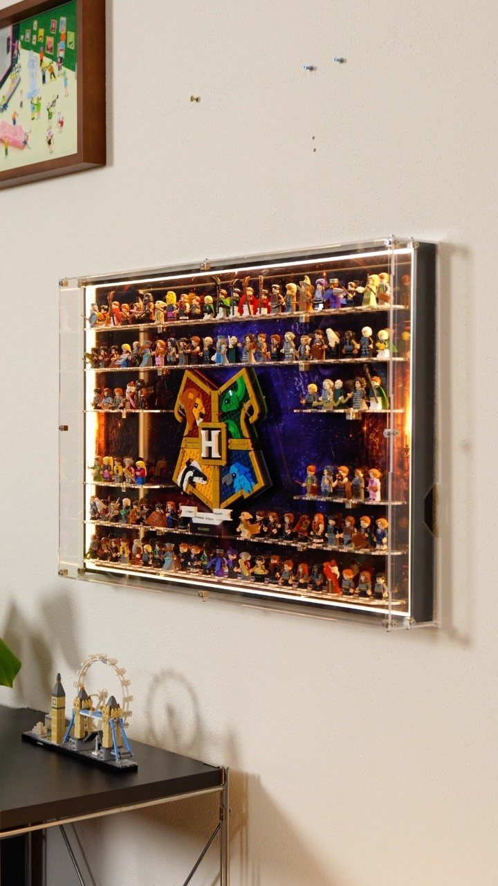 25 Best Harry Potter Gifts for Every Wizarding Fan in 2026 24 Harry Potter minifigures displayed in a clear acrylic wall case with Hogwarts crest.