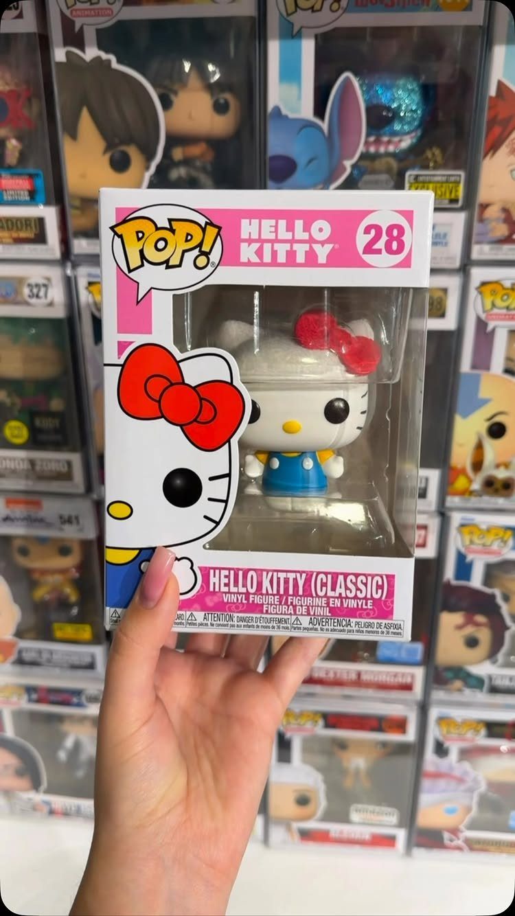 Hello Kitty Funko Pop figure in its original packaging held by a hand.
