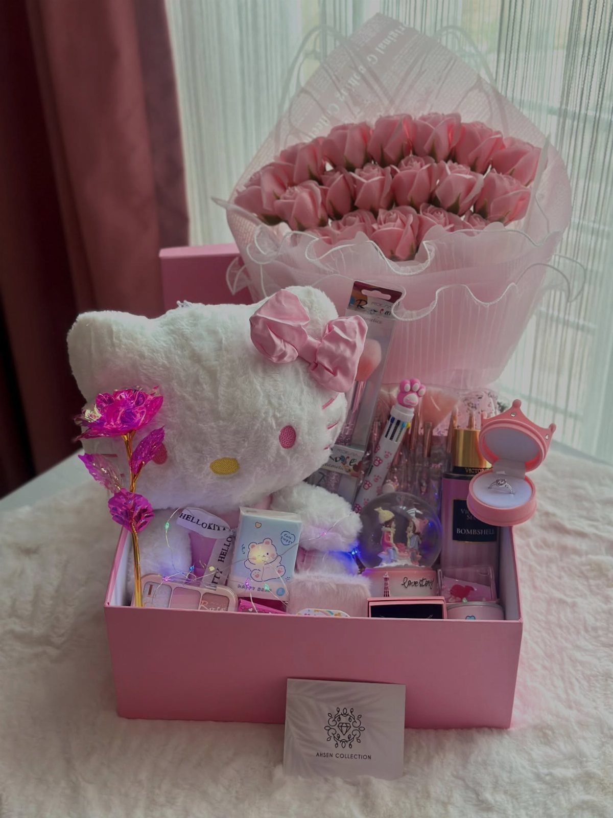 Hello Kitty plush toy and pink tulips in a pink gift box