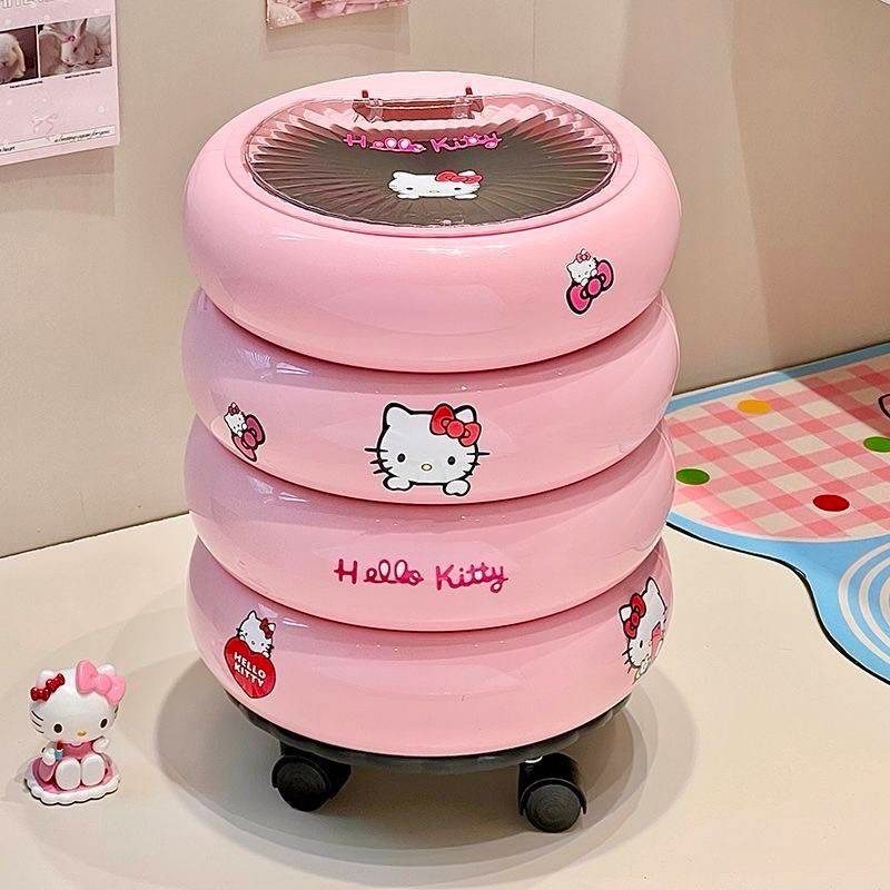 Pink Hello Kitty plastic storage drawers on wheels with a small figurine nearby.