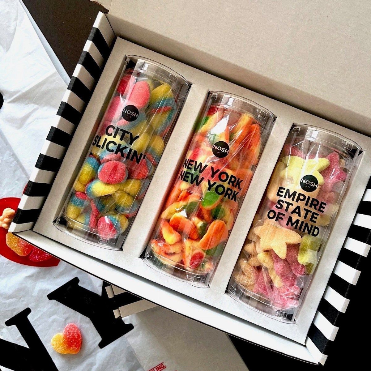 Gift box with three tubes of colorful gummy candies and New York labels.