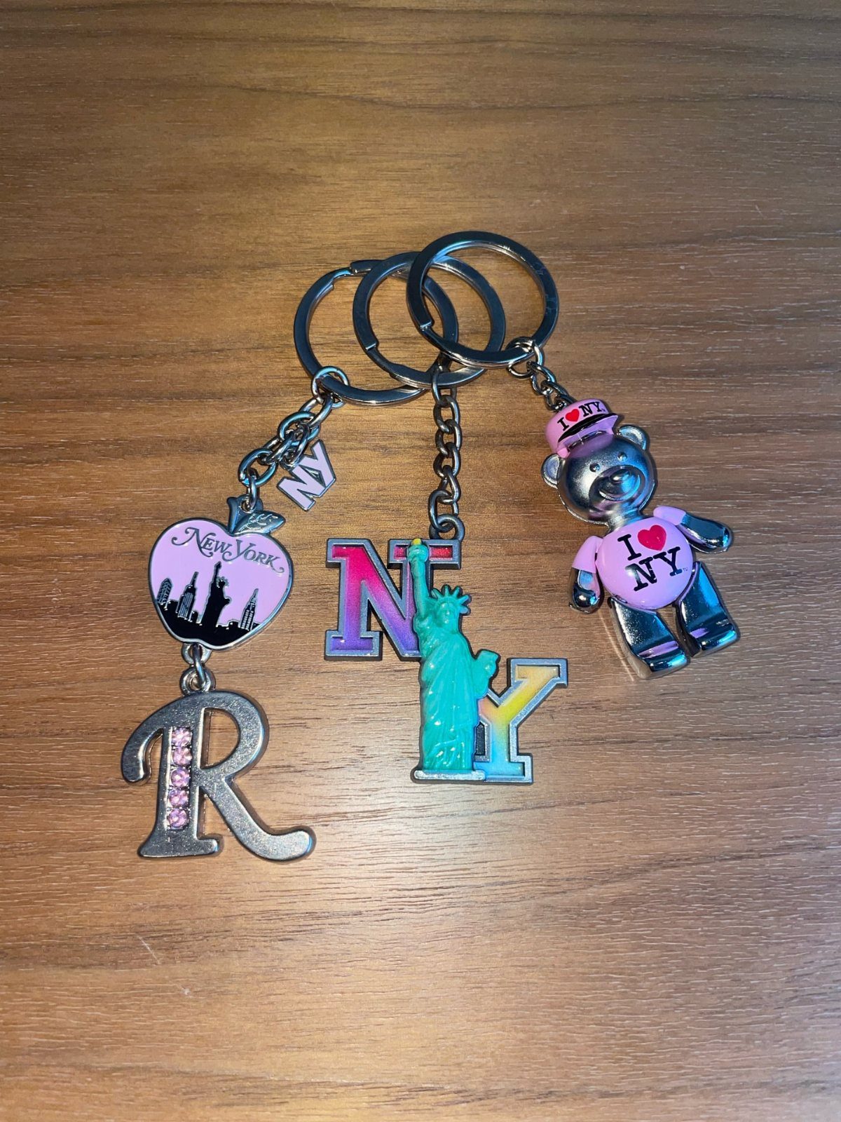 Three New York City themed keychains featuring a bear and the NY logo.