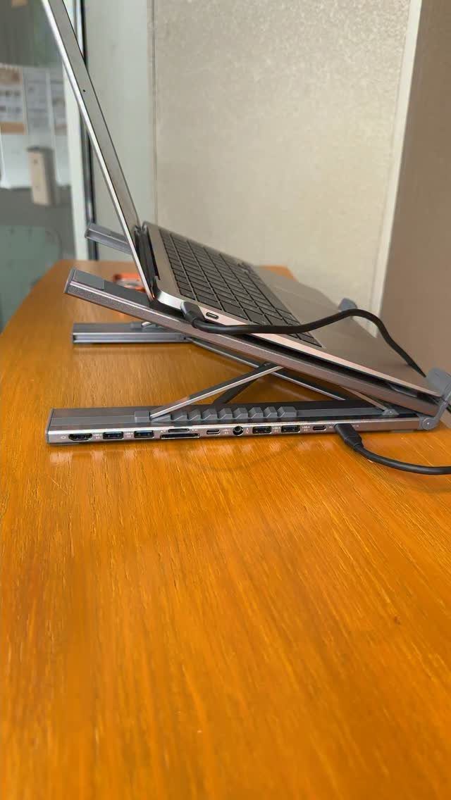 20 Ideal Boyfriend Gifts He'll Actually Use and Keep 17 Silver laptop on a metallic adjustable stand atop a wooden table