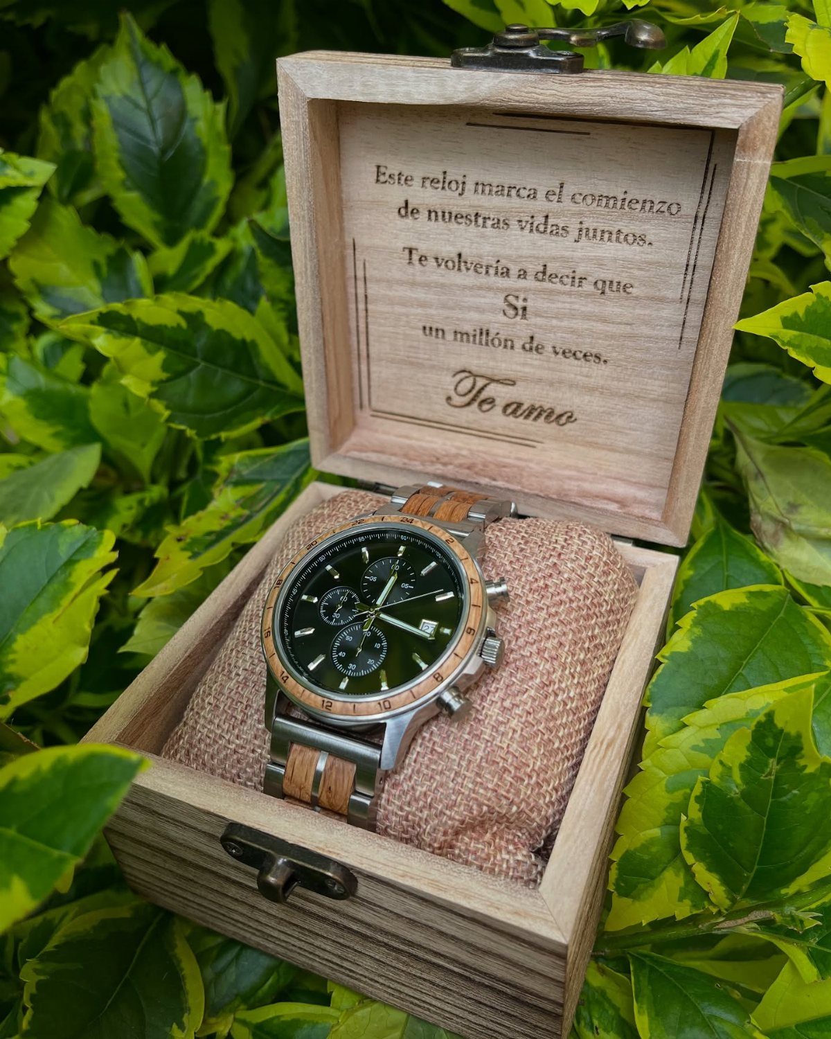 20 Ideal Boyfriend Gifts He'll Actually Use and Keep 7 Wooden and silver wristwatch in an engraved wooden box resting on green leaves