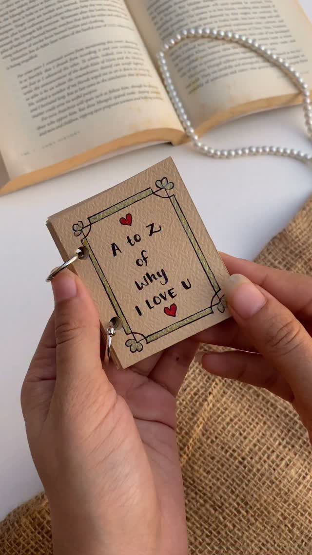 20 Ideal Boyfriend Gifts He'll Actually Use and Keep 5 Handmade A to Z of why I love you booklet held by hands