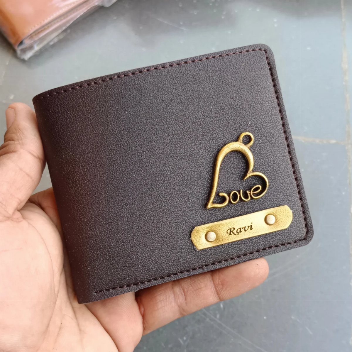 20 Ideal Boyfriend Gifts He'll Actually Use and Keep 9 Brown leather wallet with a gold heart charm and engraved name plate.