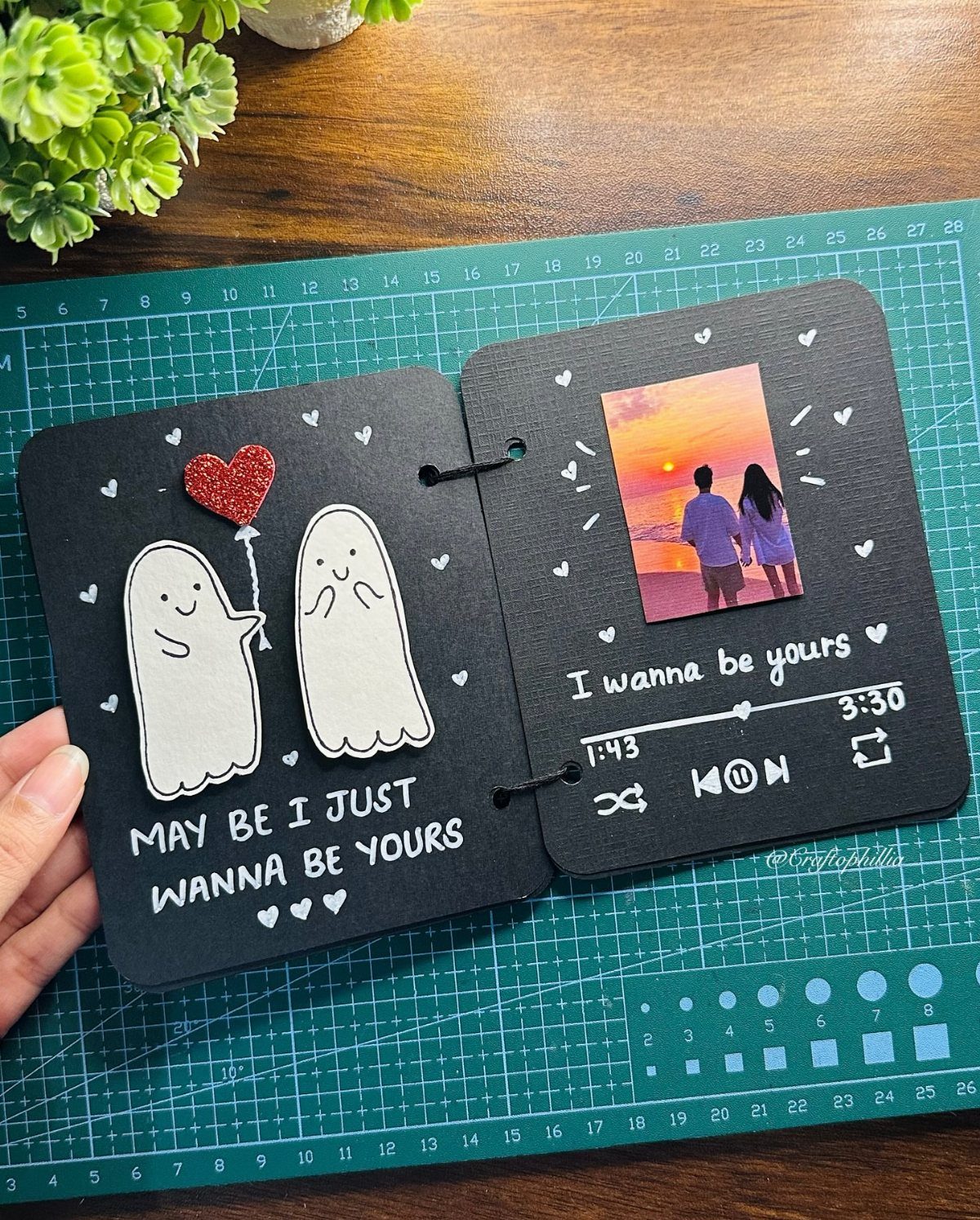 20 Ideal Boyfriend Gifts He'll Actually Use and Keep 4 Handmade black scrapbook with ghost drawings, a couple's photo, and music player art.