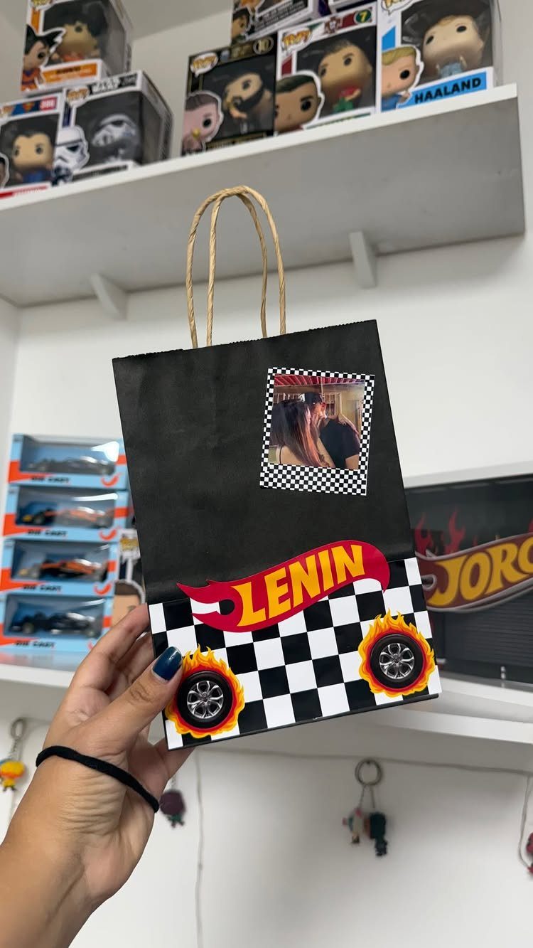 20 Ideal Boyfriend Gifts He'll Actually Use and Keep 20 Customized black gift bag with racing themes and a couple's photo for a boyfriend.