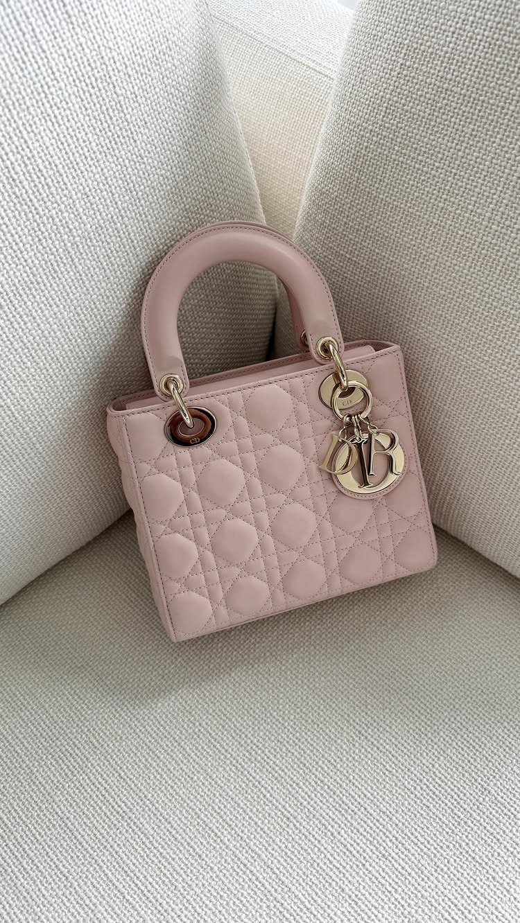 Luxury Gifts for Women: 11 Ideas from Candles to Jewelry 8 Small pink quilted leather handbag with gold hardware on white textured fabric