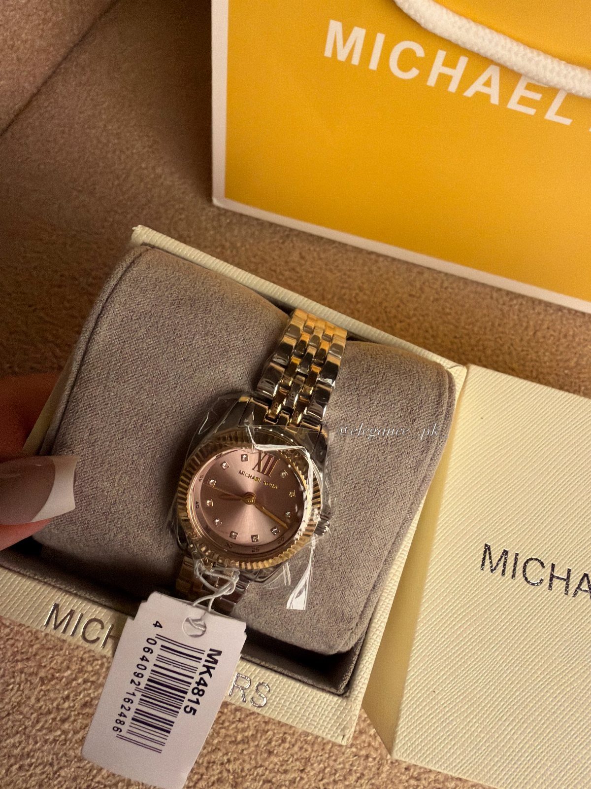 Luxury Gifts for Women: 11 Ideas from Candles to Jewelry 7 Gold Michael Kors wristwatch with pink face in a white branded gift box