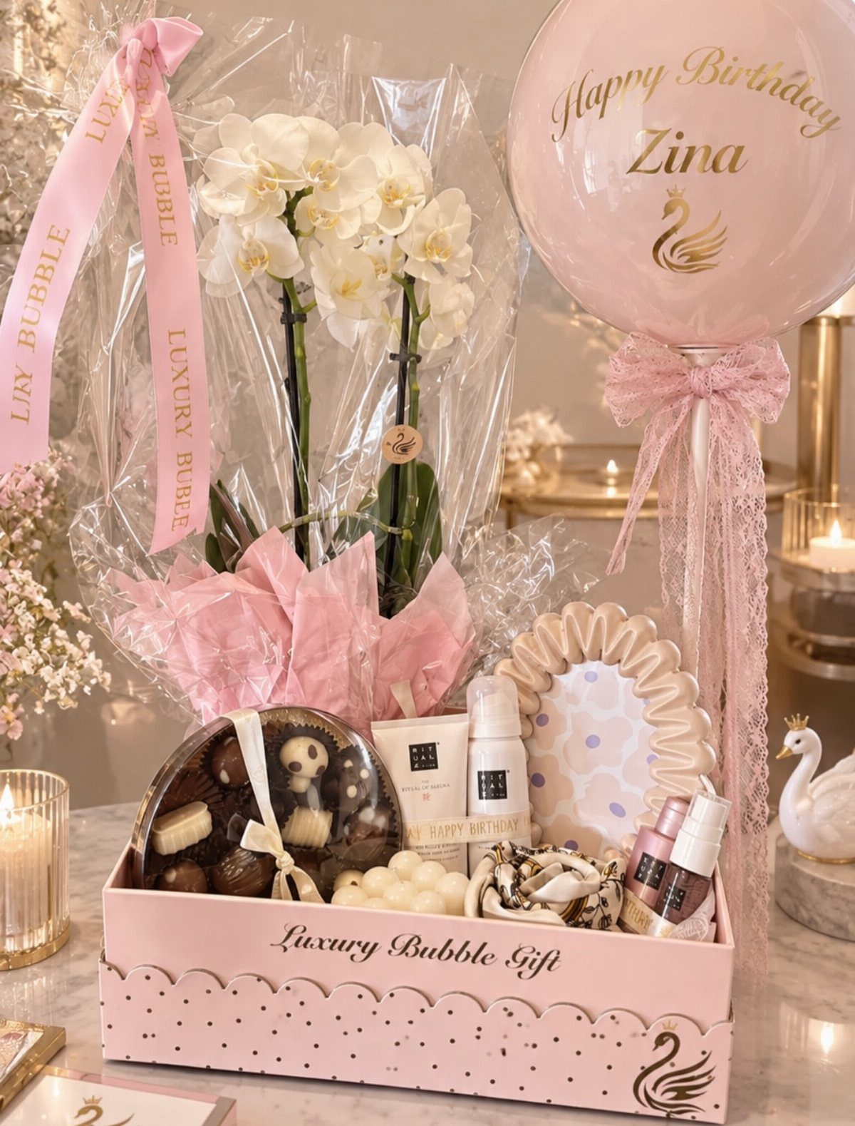 Luxury Gifts for Women: 11 Ideas from Candles to Jewelry 3 Personalized birthday gift set with white orchids, skincare, and a custom name balloon.