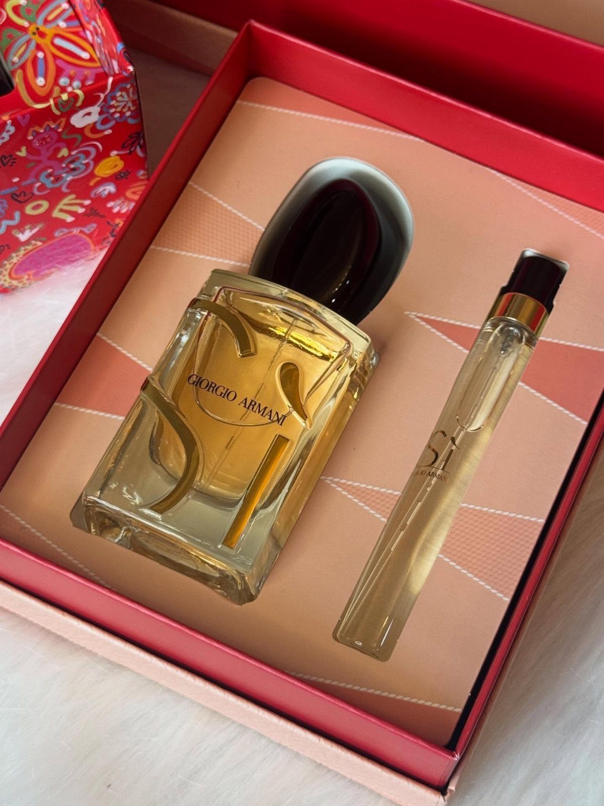 Giorgio Armani perfume gift set with two bottles in a red striped box