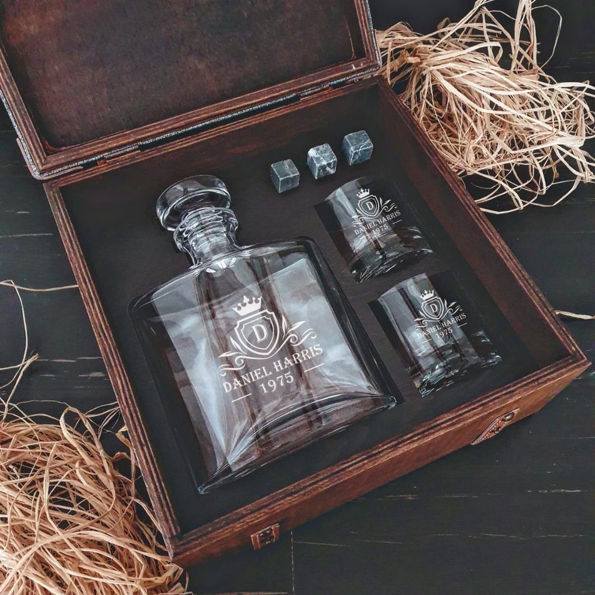 Engraved whiskey decanter and glasses set in a wooden gift box with chilling stones.