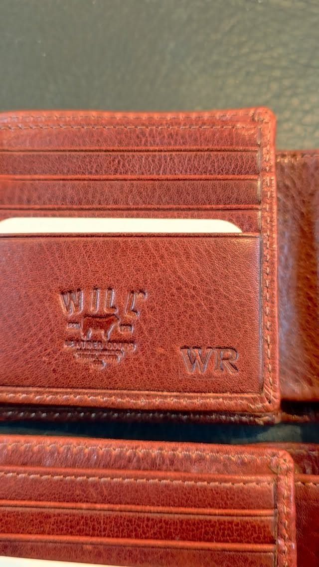 Brown leather wallet with embossed WR monogram and a brand logo.