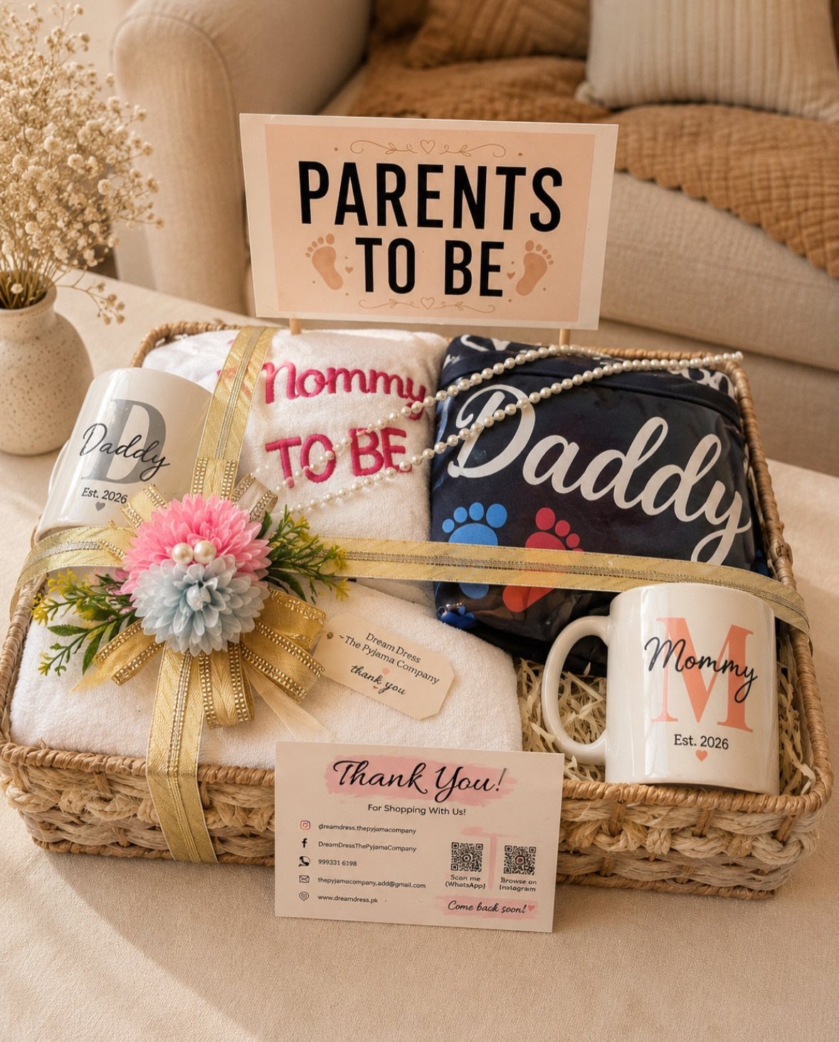 Gift basket for parents to be with matching mugs, towels, and a sign.