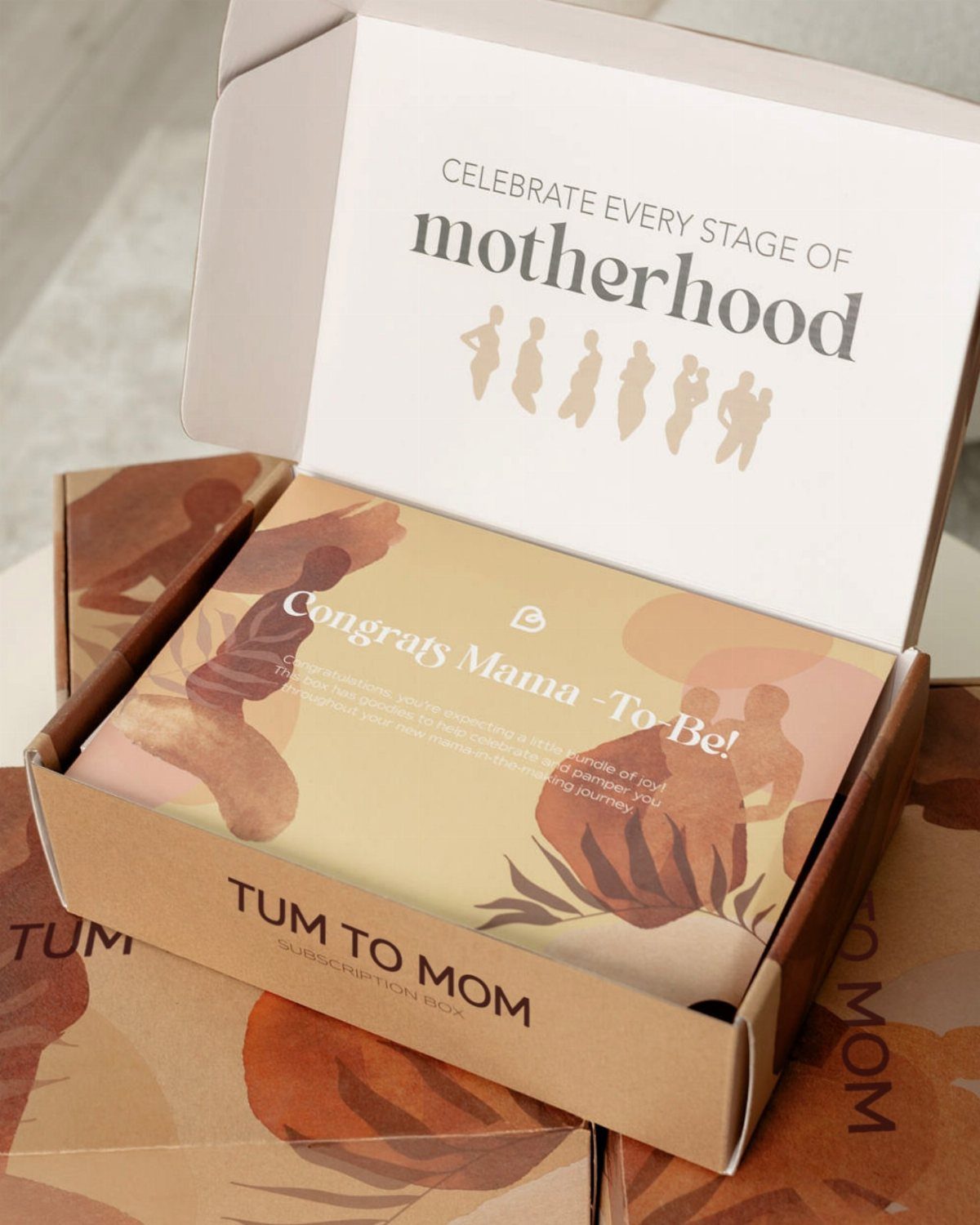 Open Tum to Mom subscription box with a congratulatory card for expectant mothers.