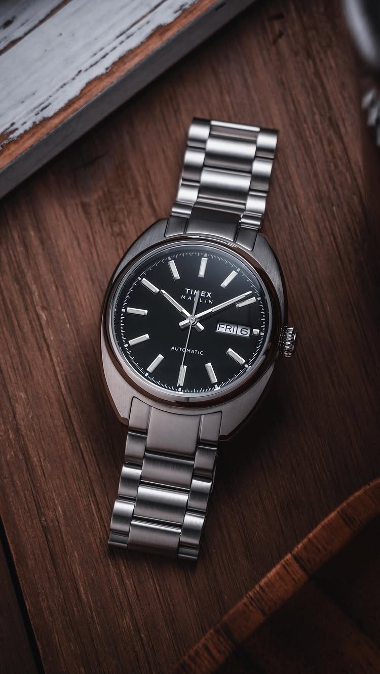 National Boyfriend Day Gifts: 12 Ideas for Him 3 Timex Marlin automatic watch with black face and silver stainless steel bracelet on wood