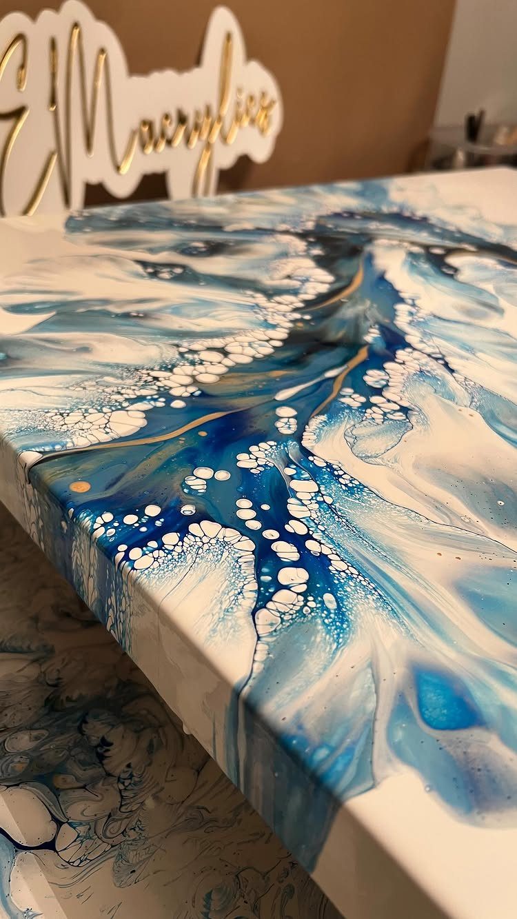 12 Paintings as Gifts for Every Budget and Taste 12 Abstract blue and white fluid acrylic painting with gold accents on canvas