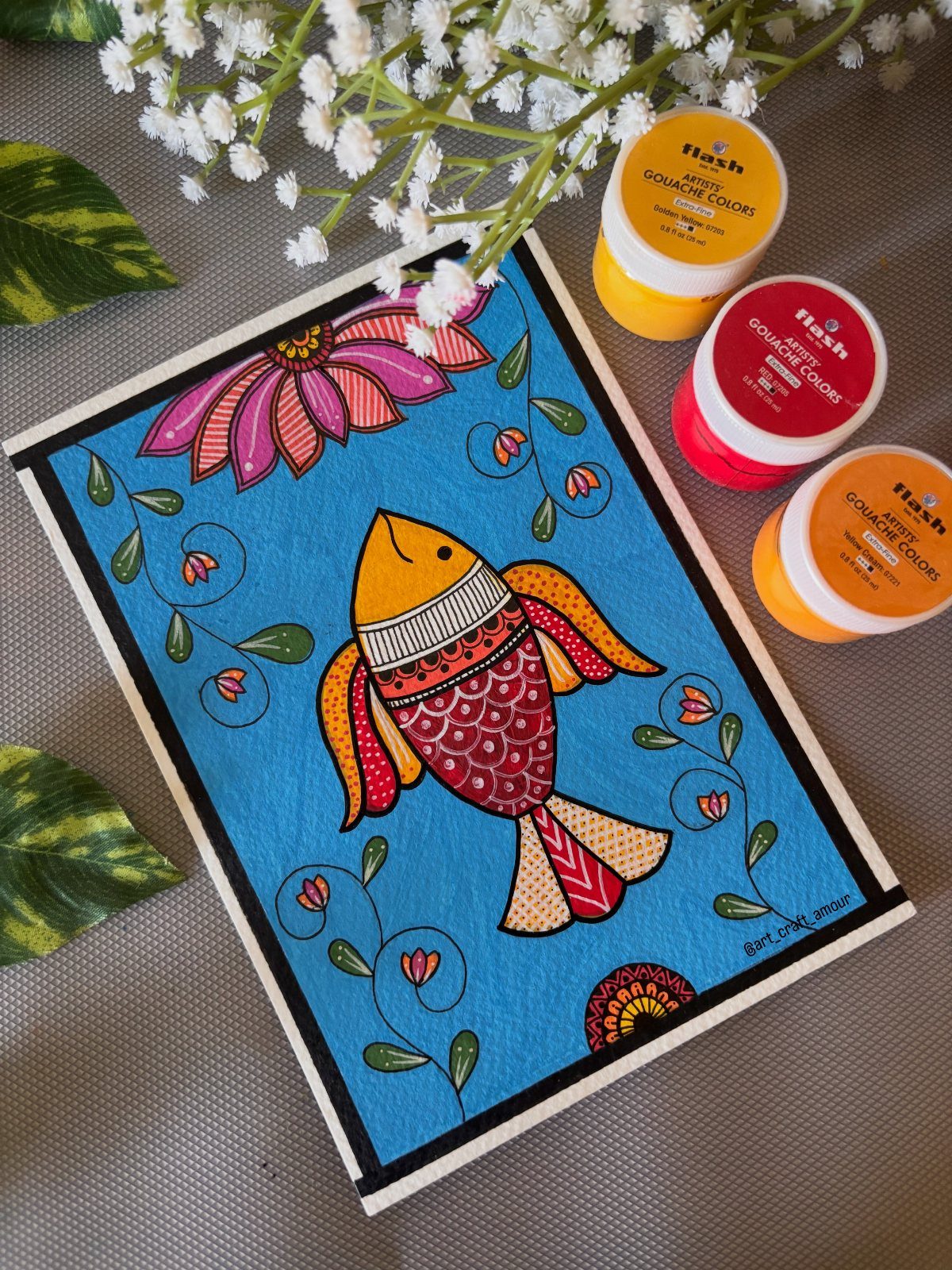 12 Paintings as Gifts for Every Budget and Taste 7 Colorful painting of a stylized fish and flower with gouache paint jars.