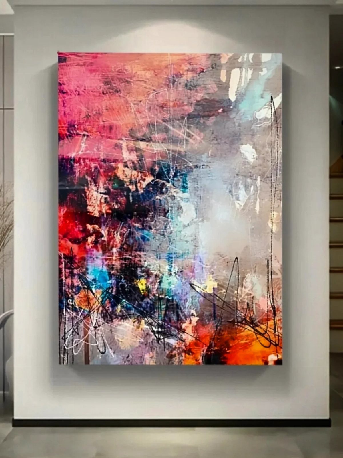 12 Paintings as Gifts for Every Budget and Taste 11 Abstract colorful painting with pink and blue tones hanging on a white wall