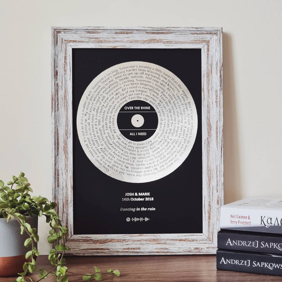 Framed vinyl record art with handwritten text, names, and a wedding date.