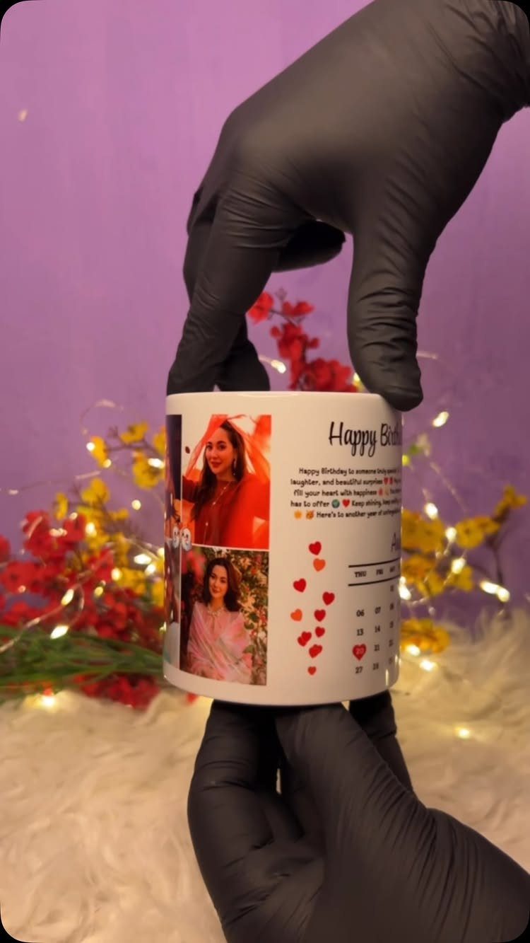 White ceramic mug with printed photos and birthday text held by gloved hands.