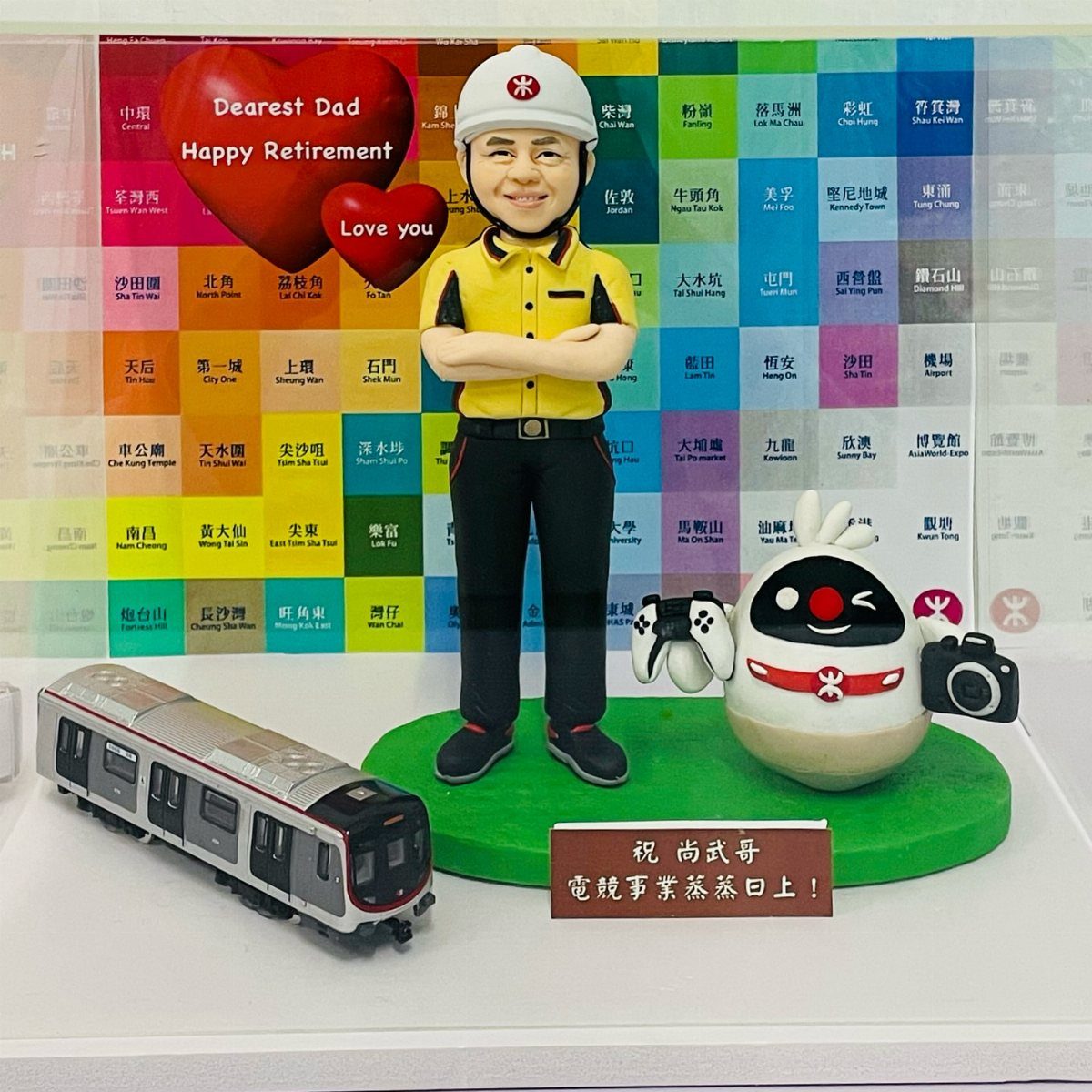 Custom bobblehead of a man in uniform with a model train and retirement message.