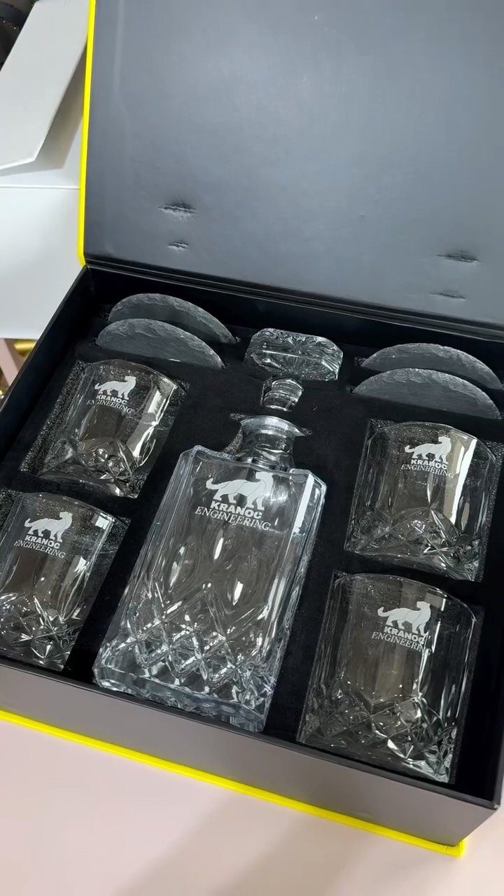 Engraved crystal whiskey decanter and four glasses in a black gift box.