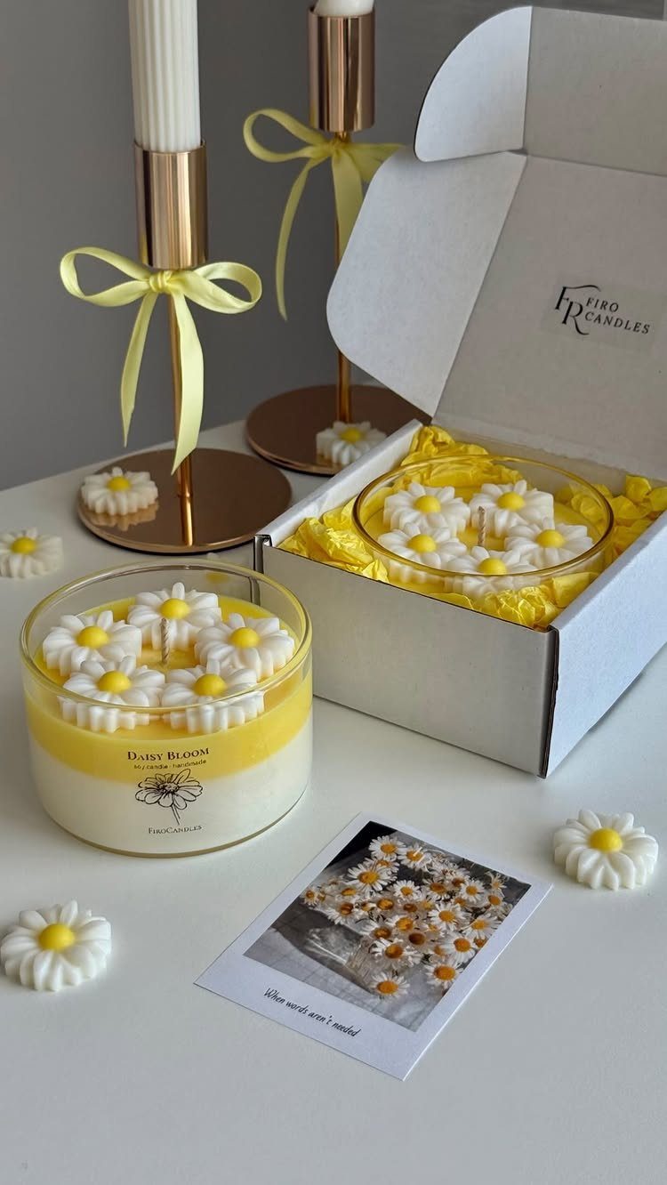 Yellow daisy-themed candle set in a white gift box with gold candle holders.