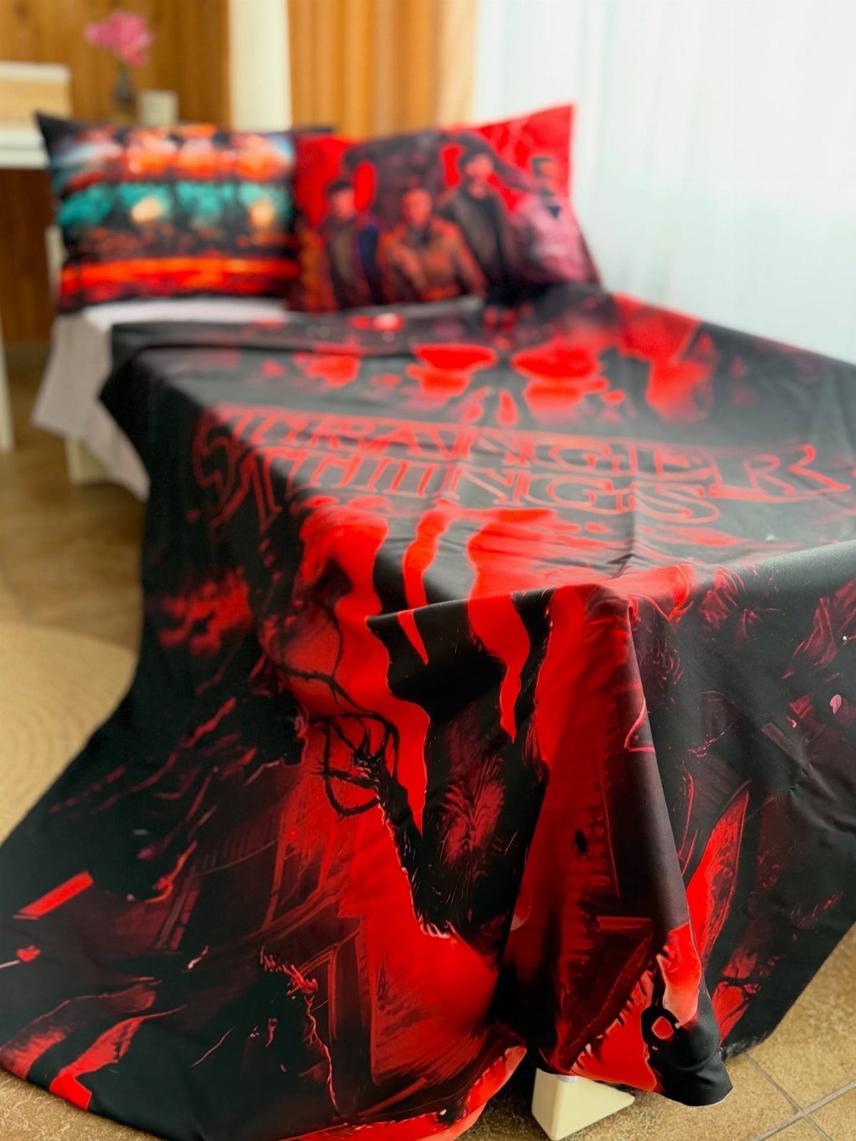 Stranger Things themed bedding set with red and black duvet and pillows.
