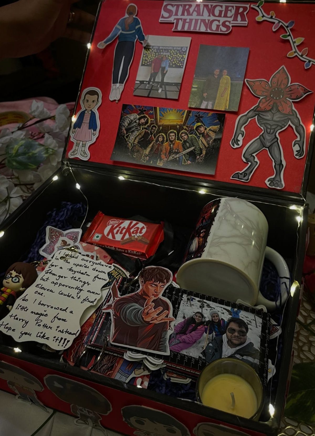 Stranger Things themed gift box containing a mug, candy, and character cutouts
