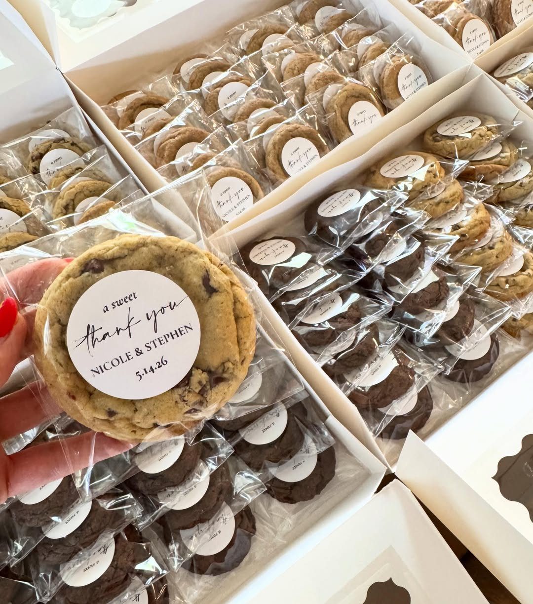 Chocolate chip cookies in clear bags with thank you labels in white boxes