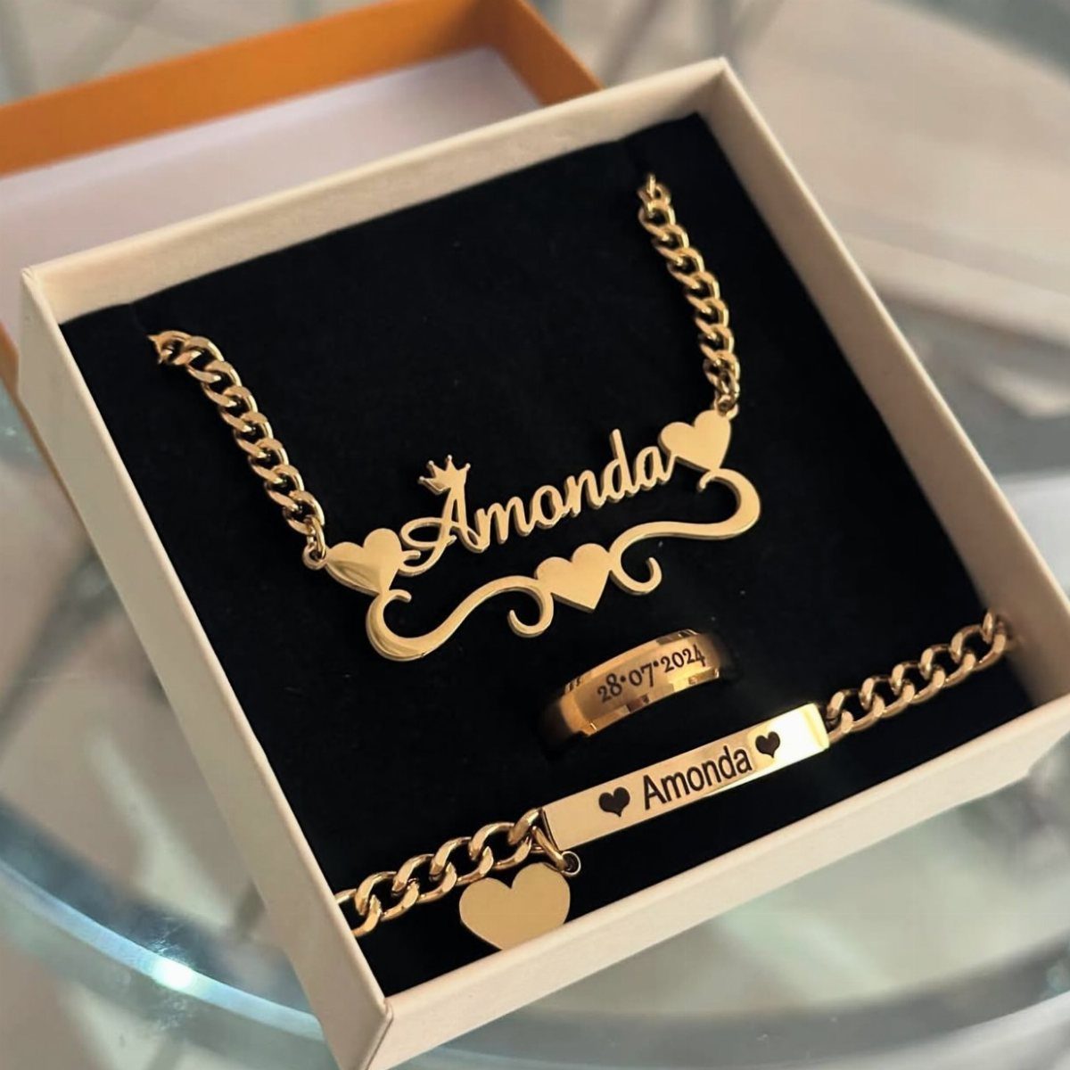 Gold personalized jewelry set with the name Amonda in a white gift box.