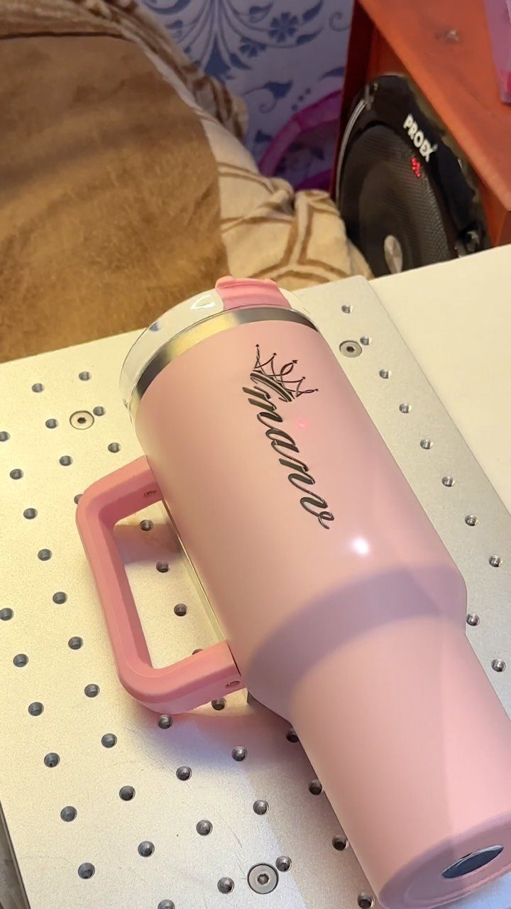 Pink personalized tumbler with the name Anne and a crown on a white surface
