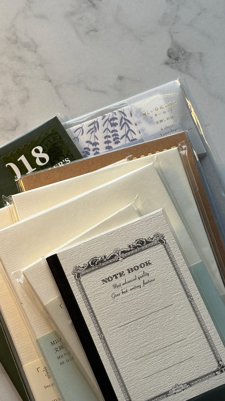 Stationery gift set with a notebook and envelopes on a marble background