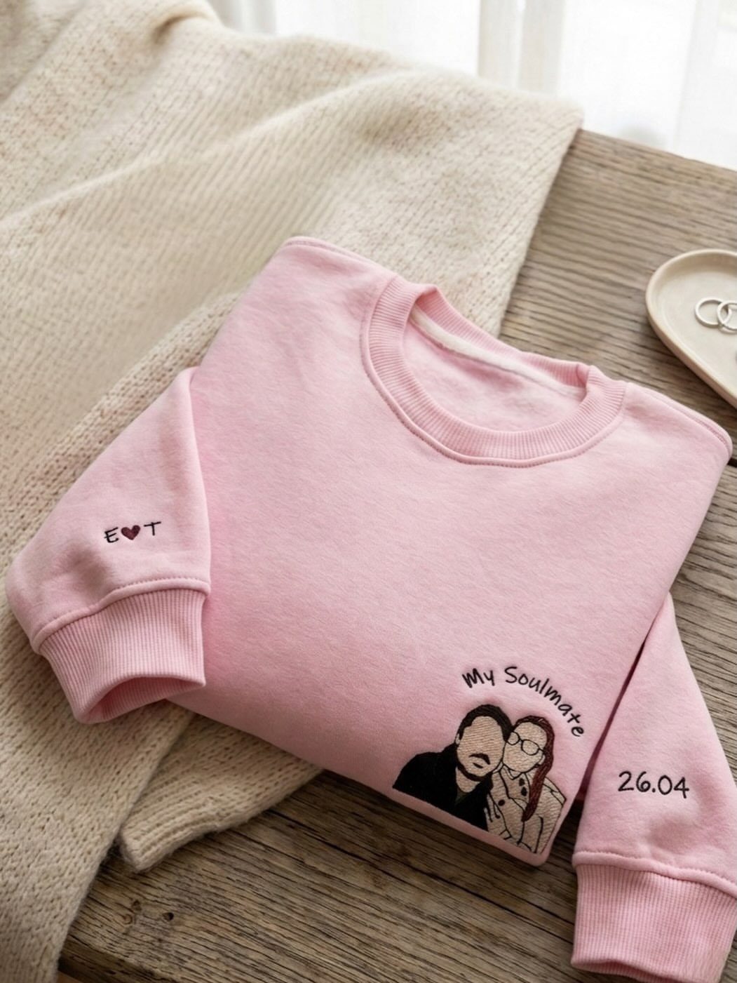 Pink embroidered sweatshirt with a couple's portrait and the words My Soulmate.