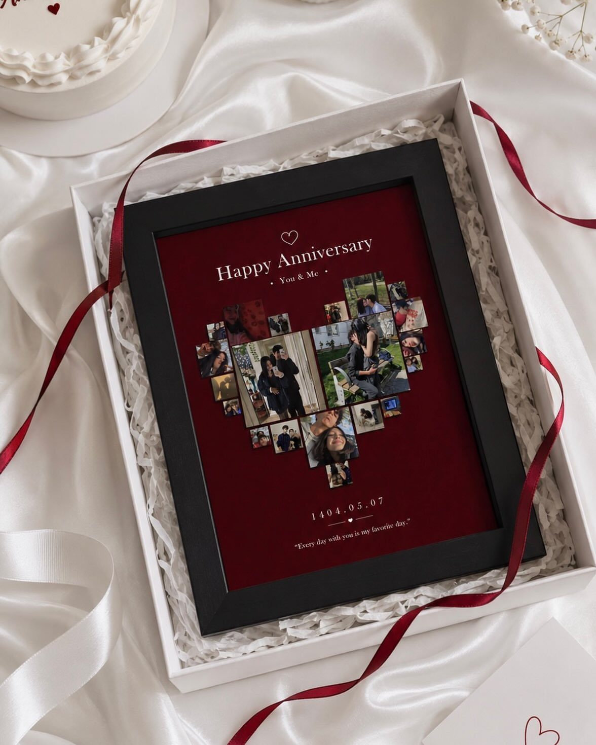Heart-shaped photo collage in a black frame inside a white gift box.