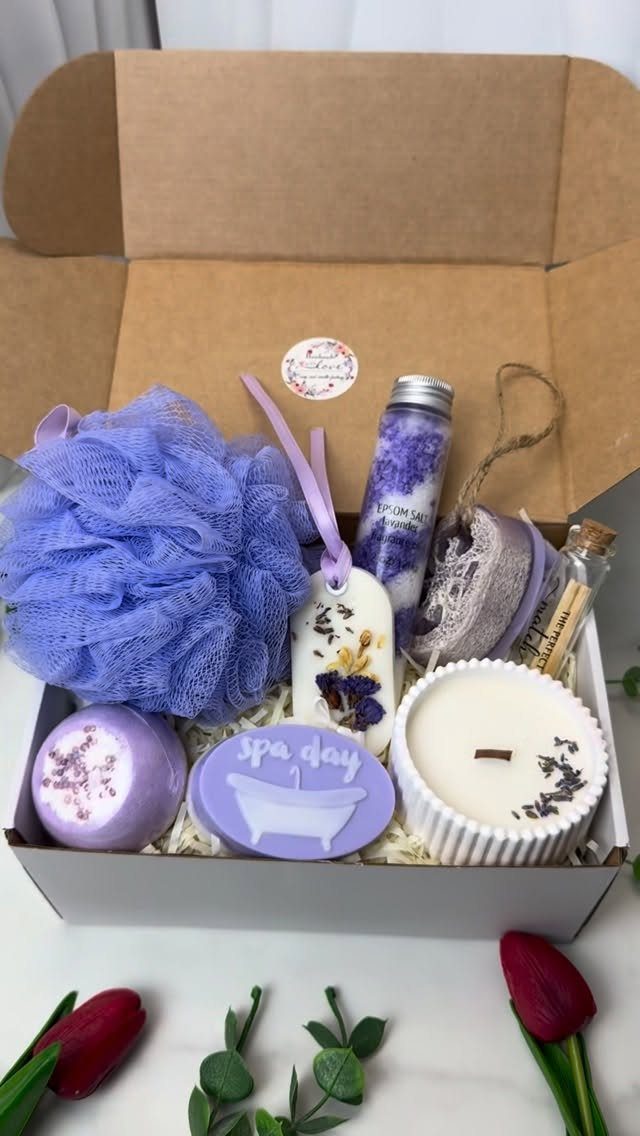 Purple spa gift set in a cardboard box with bath bomb and candle