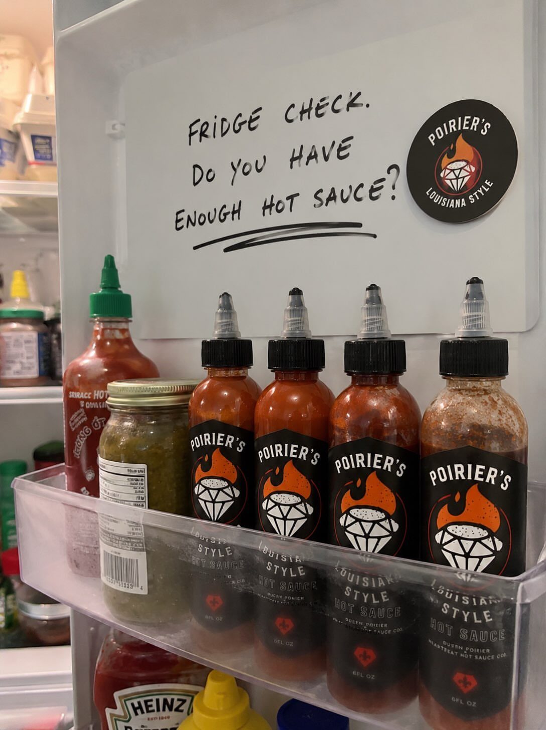12 Useful Gifts for Men: From Chef's Knives to Multitools 6 Four bottles of hot sauce and a relish jar on a refrigerator shelf.