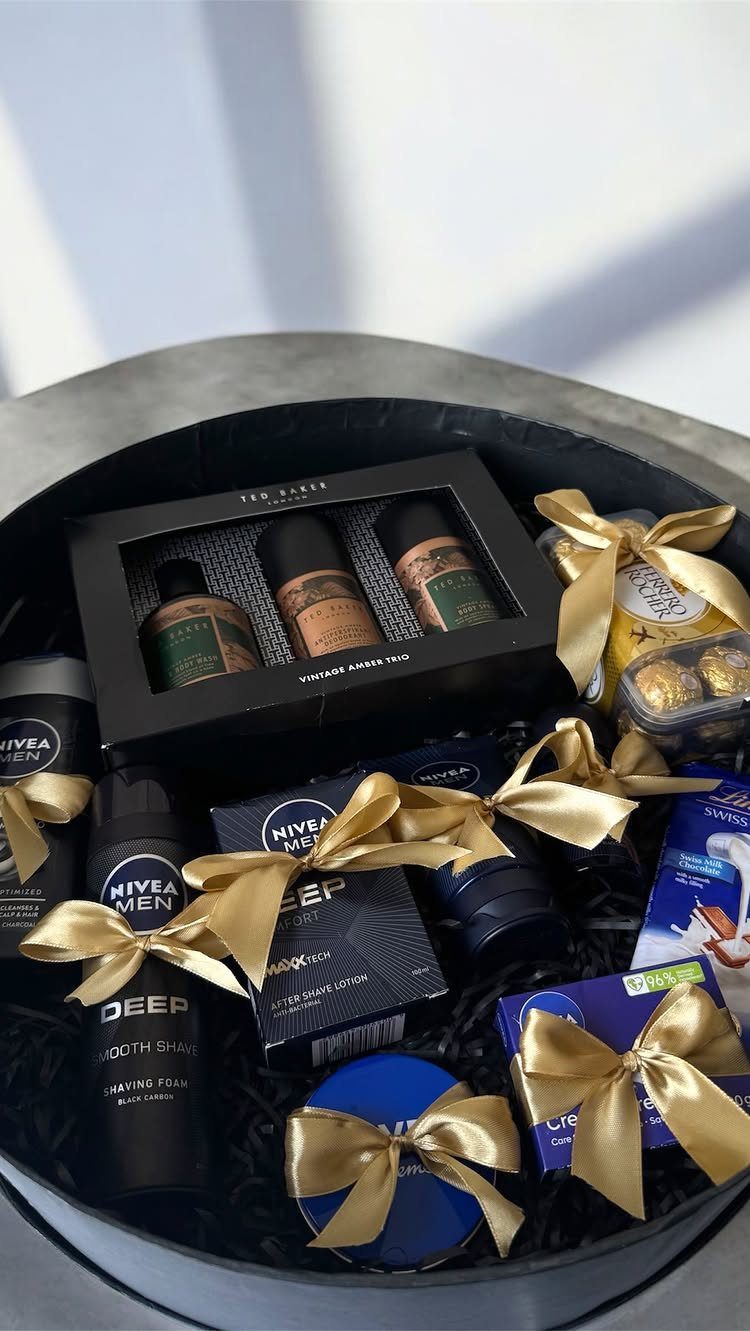 12 Useful Gifts for Men: From Chef's Knives to Multitools 2 Grooming kit with Nivea Men products and chocolates in a black gift box.