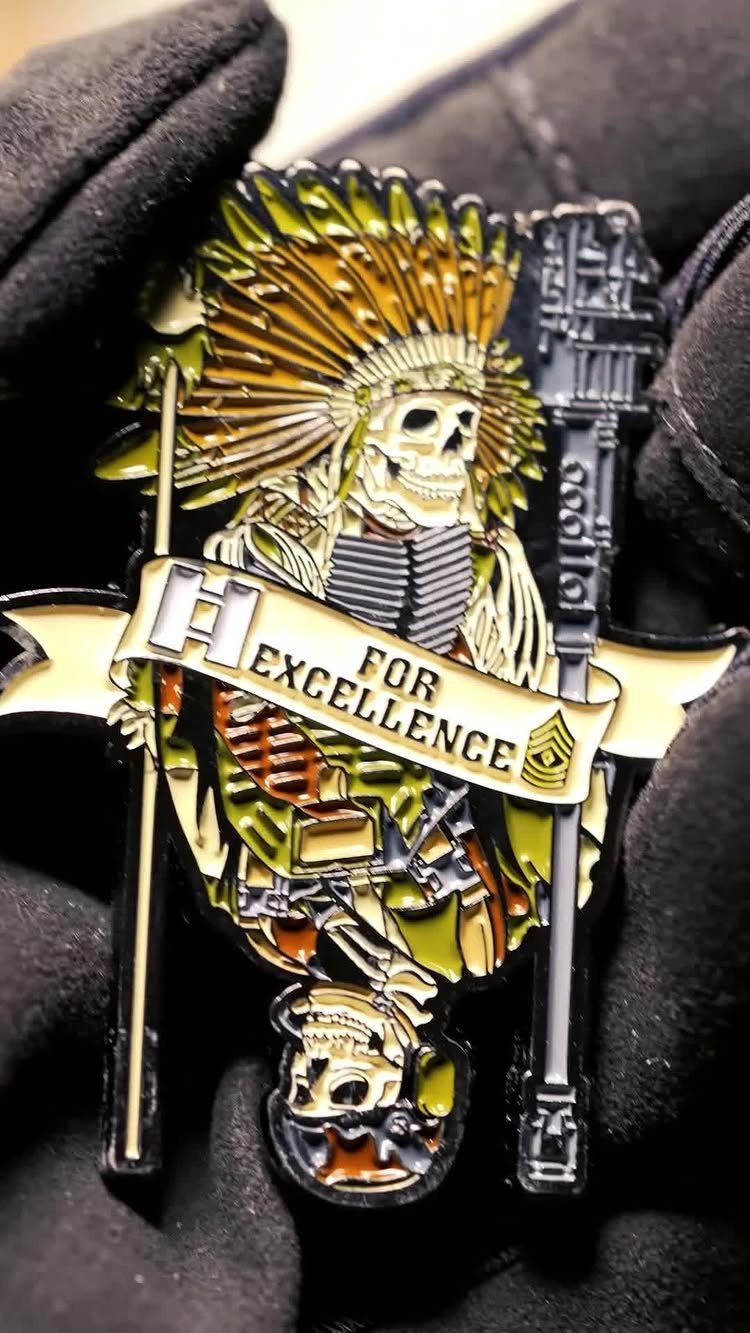 Enamel pin of a skeleton in military gear and headdress held by gloved hand