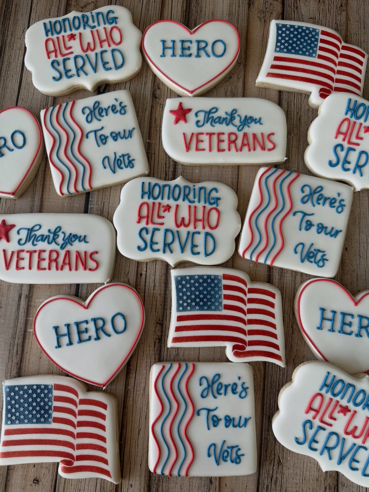 Patriotic sugar cookies with American flags and veteran tributes on a wooden background