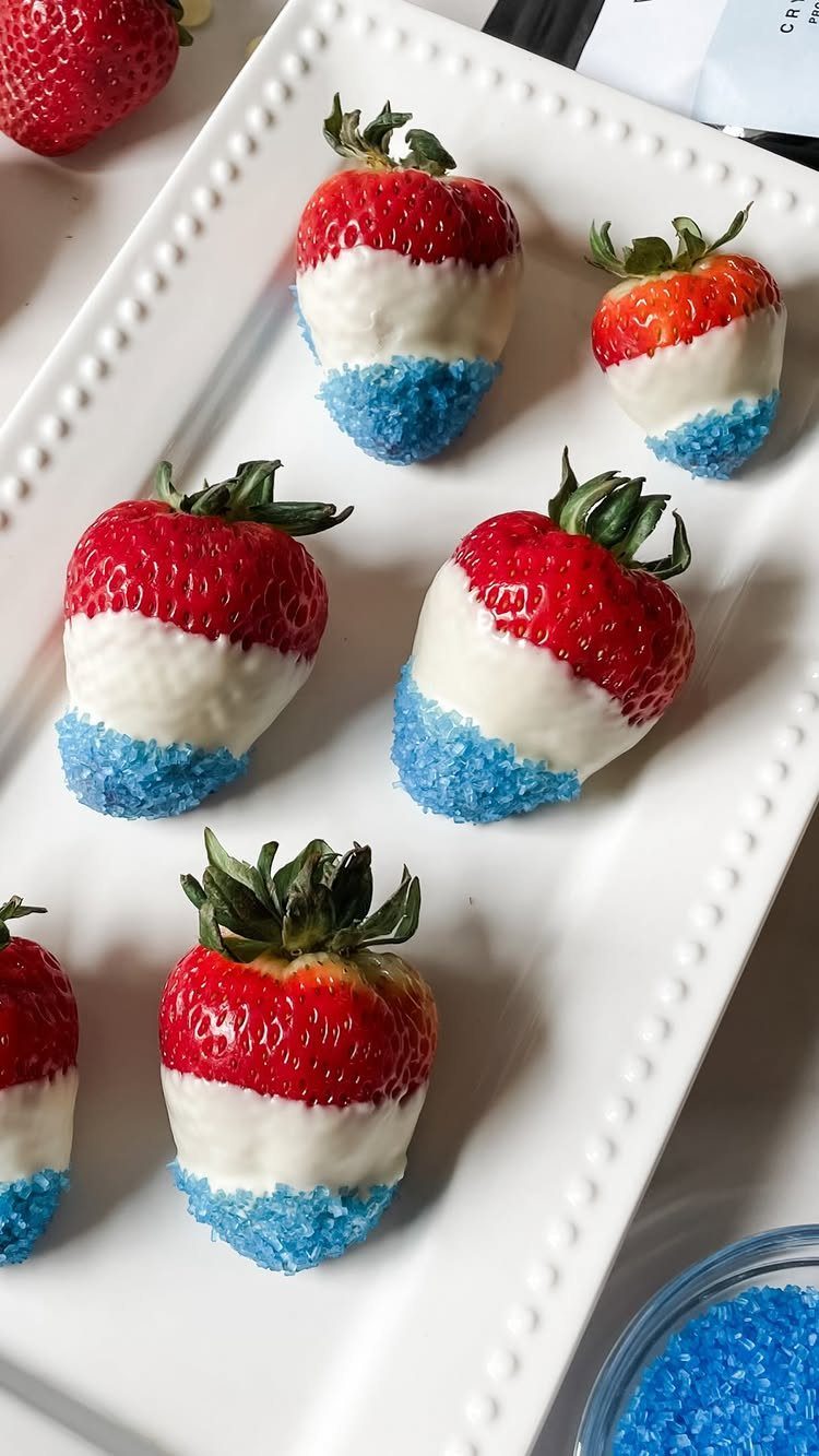 Red, white, and blue chocolate-dipped strawberries on a white beaded platter.