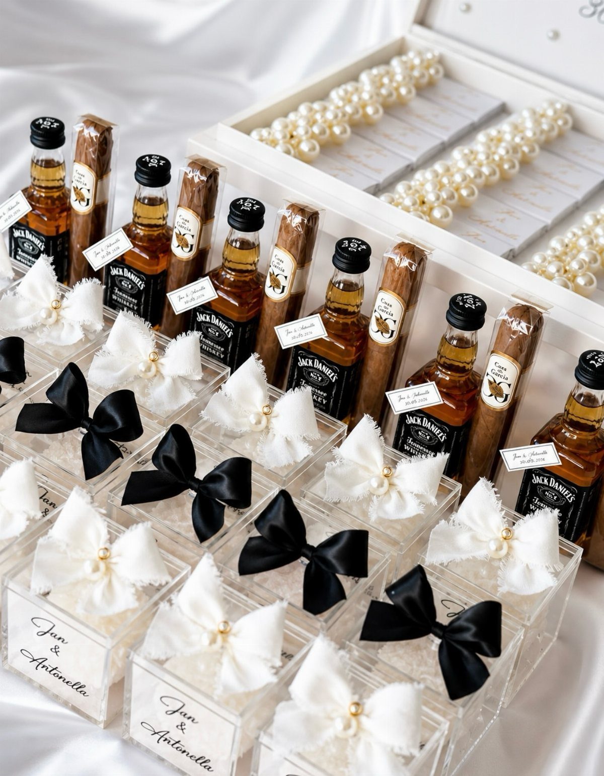 Mini whiskey bottles and cinnamon sticks in gift boxes with satin bows.
