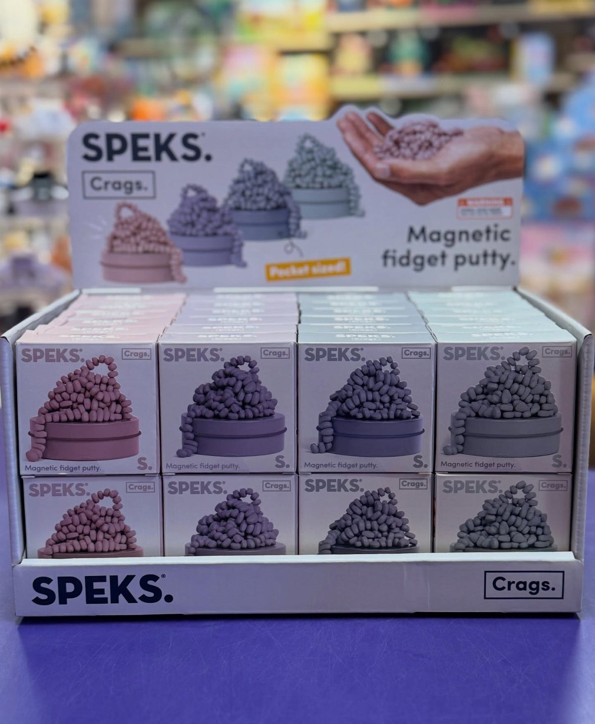 Speks Crags magnetic fidget putty retail display box with multiple small product packages.