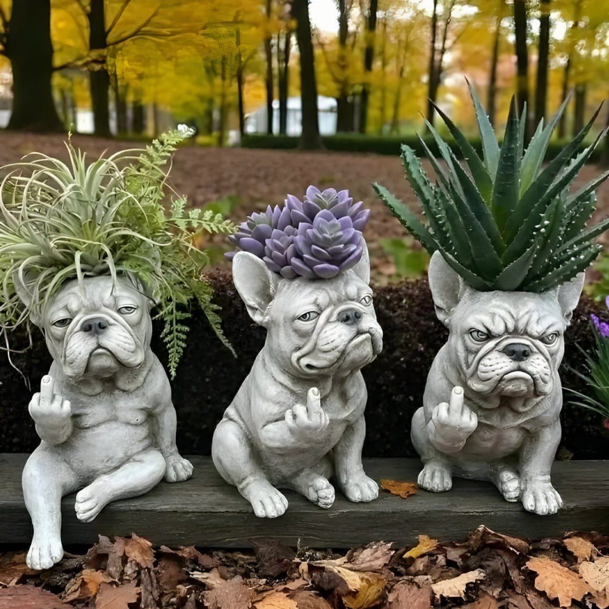 Three grey bulldog planters gesturing with middle fingers, holding various small green plants.