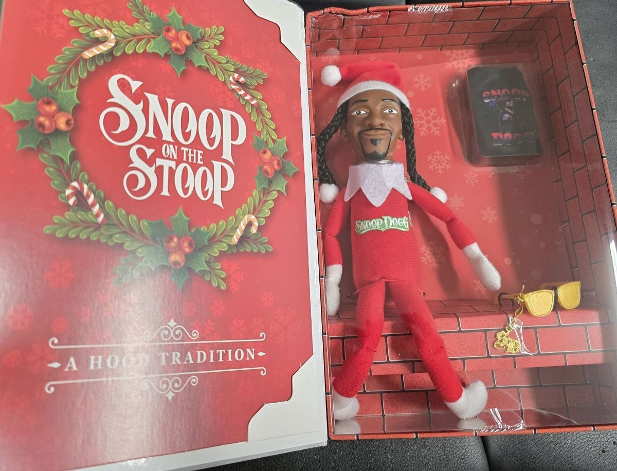 Snoop on the Stoop elf figurine in red holiday attire inside its packaging.
